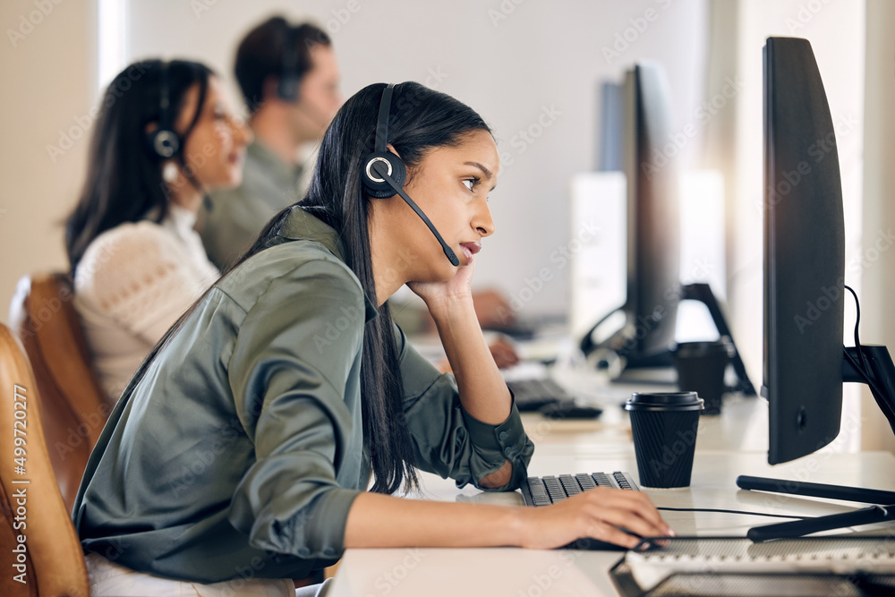 Why does this webpage always take forever to load. Shot of a young call centre agent looking bored while working on a computer in an office. Why does this webpage always take forever to load. Shot of a young call centre agent looking bored while working on a computer in an office.