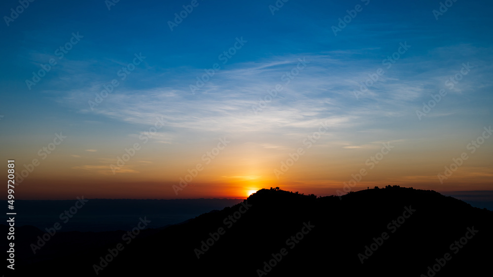 Beautiful sunrise landscape on the mountain of thailand. Golden and blue sky sunrise in the morning.