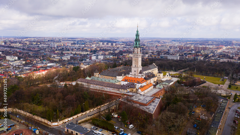 Aerial view of active Catholic Jasna Gora Monastery in Czestochowa on background with modern cityscape in spring, Poland