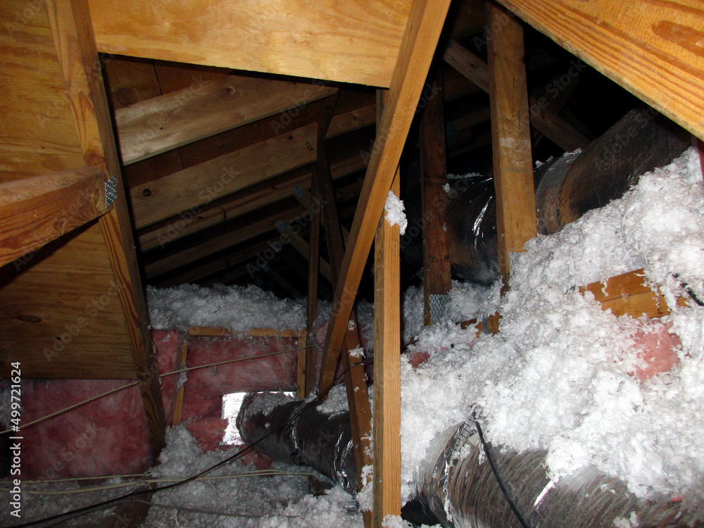 Insulation and Venting Pipes and Tubes in Attic Crawl Space with Wooden Roof Rafter Supports 素材庫