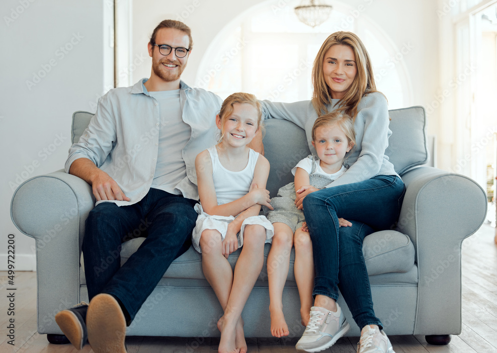 Obraz premium All weve ever wanted. Shot of a young family happily bonding together on the sofa at home.