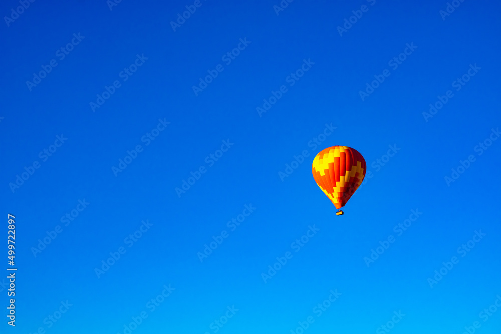 Hot Air Balloon. Single hot air balloon isolated on clear blue sky Hot Air Balloon. Single hot air balloon isolated on clear blue sky