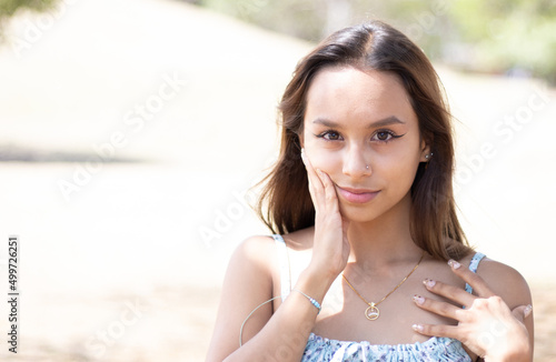 Young latina woman enjoying sunny afternoon in Costa Rica. Empowered woman, professional, woman in her 20's. LGTBI woman. young latina woman shopping. out of focus background. copy space for advertisi
