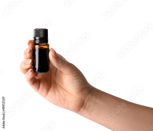 Female hand with bottle of iodine on white background