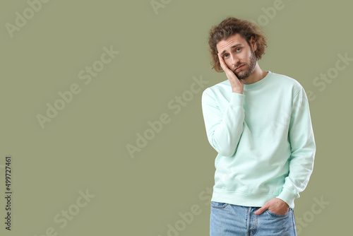 Sad young man in sweatshirt...