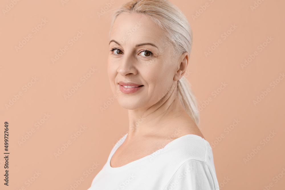 Mature blonde woman with healthy skin on beige background Mature blonde woman with healthy skin on beige background