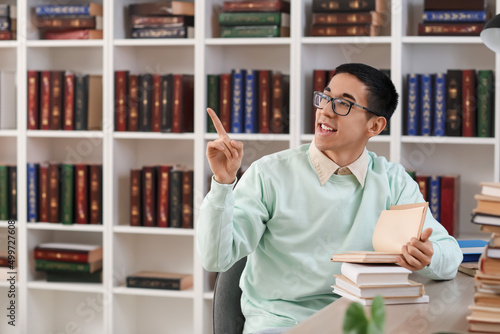 Male Asian student with boo...