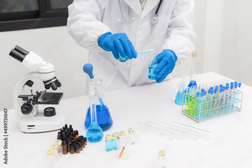 Fototapeta premium Medical Science Laboratory: Portrait of a beautiful scientist looking under a microscope analyzing a test sample. Ambitious young biotechnology specialist work with advanced equipment