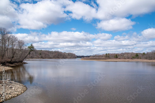 Christie Lake, a small lake beside the ghost town of Crooks Hollow in Hamilton, Ontario, is seen under a blue, partially cloudy sky.