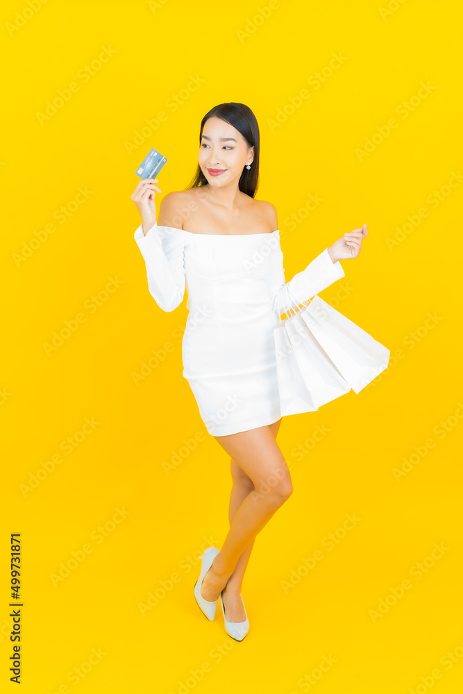 Portrait beautiful young business asian woman with shopping bag from department store and mall Portrait beautiful young business asian woman with shopping bag from department store and mall