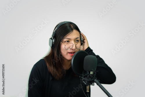 Woman (LGBTQ) singer sing a song with microphone photo