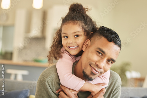 Dads the strongest. Portrait of a young father and daughter bonding on the sofa at home.