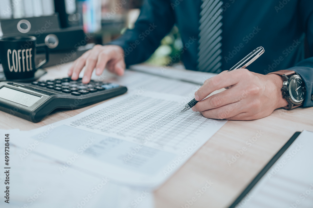 Accountant writing, checking and working on company data, document, report and calculator to calculate on desk office. Accounting business concept. Accountant writing, checking and working on company data, document, report and calculator to calculate on desk office. Accounting business concept.