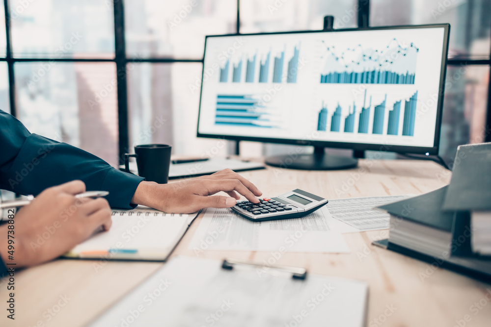 © Charnchai saeheng - Investors working on desk office and using a calculator to calculate balance, projit, currency and cost. Accounting and  Financial concept. © Charnchai saeheng - Investors working on desk office and using a calculator to calculate balance, projit, currency and cost. Accounting and  Financial concept.