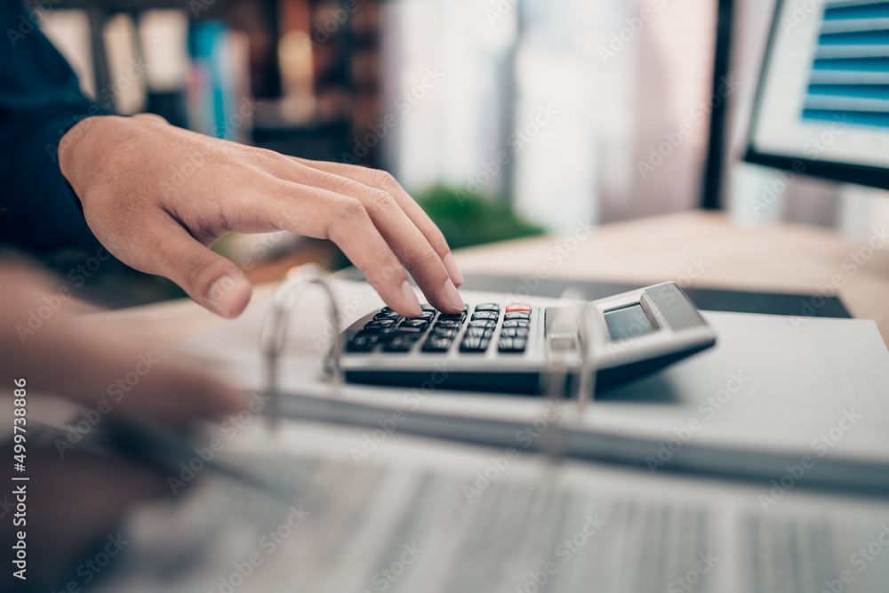 Investors working on desk office and using a calculator to calculate balance, projit, currency and cost. Accounting and Financial concept. Investors working on desk office and using a calculator to calculate balance, projit, currency and cost. Accounting and Financial concept.