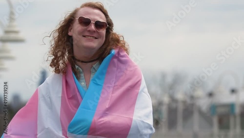 Happy Trans woman with a trans flag photo