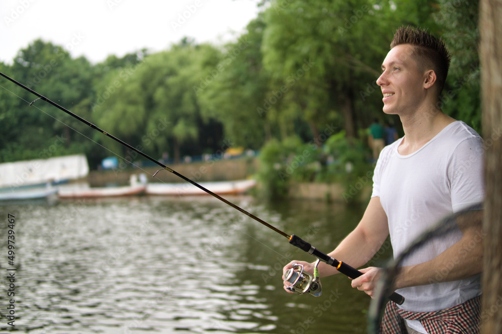 Young man fishing on a lake. Young man fishing on a lake.