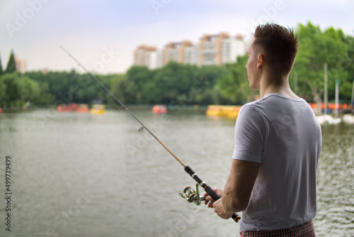 Young man fishing on a lake.