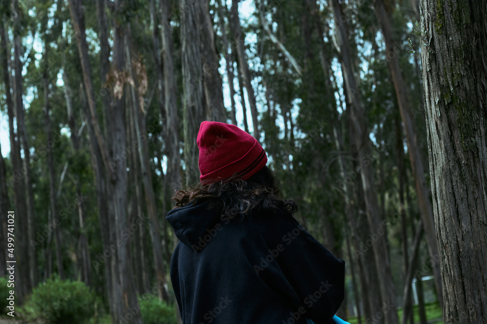 Woman standing in gloomy forest in summer Woman standing in gloomy forest in summer