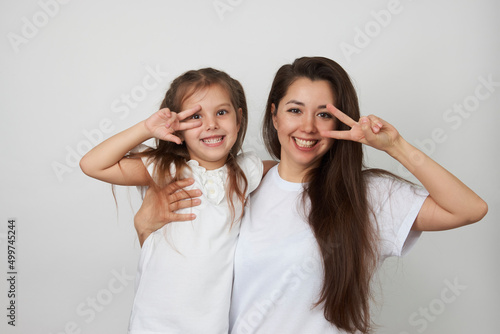 Happy woman and child girl 5-6 years old having fun