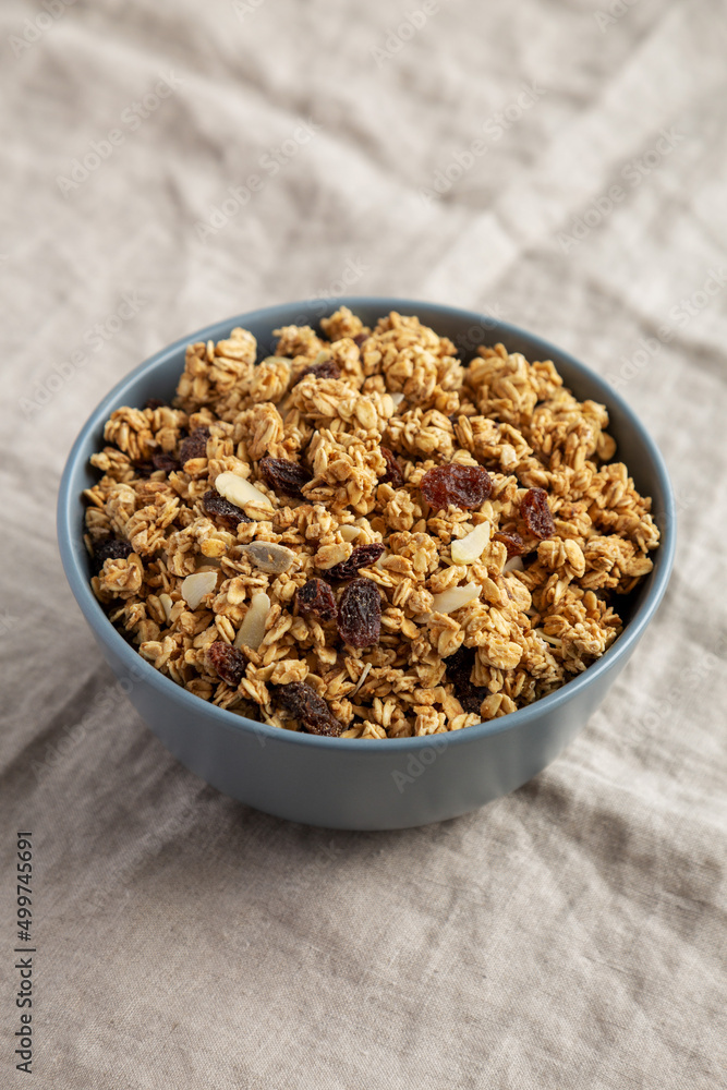 Homemade Granola with raisins and almonds in a Bowl, side view. Homemade Granola with raisins and almonds in a Bowl, side view.