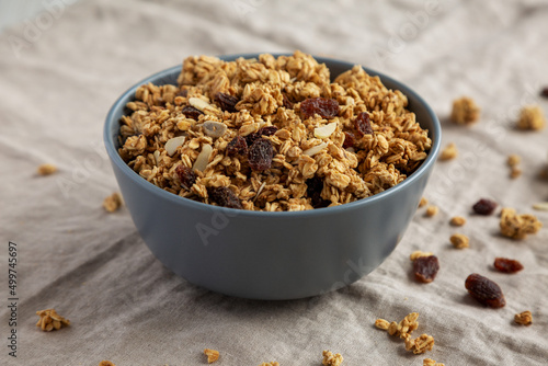 Homemade Granola with raisins and almonds  in a Bowl, side view. photo