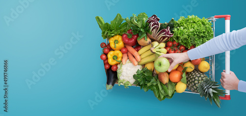 Woman buying fresh greens at the store