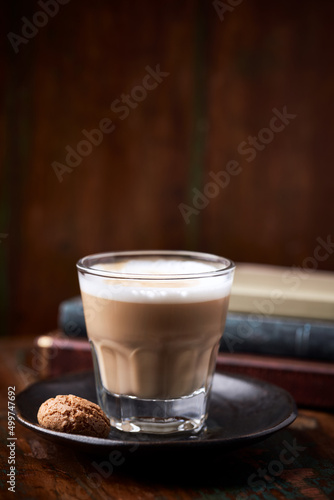Coffee with milk on rustic wooden background. Soft focus. Close up. Copy space. 