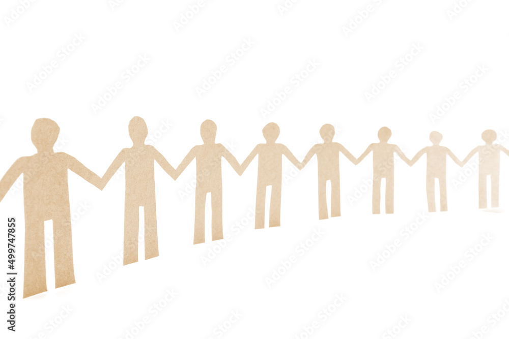 Paper human doll holding hands in a row. Unity concept. Team work and co-workers. Strong togetherness. Solidarity collaboration. Paper human doll holding hands in a row. Unity concept. Team work and co-workers. Strong togetherness. Solidarity collaboration.