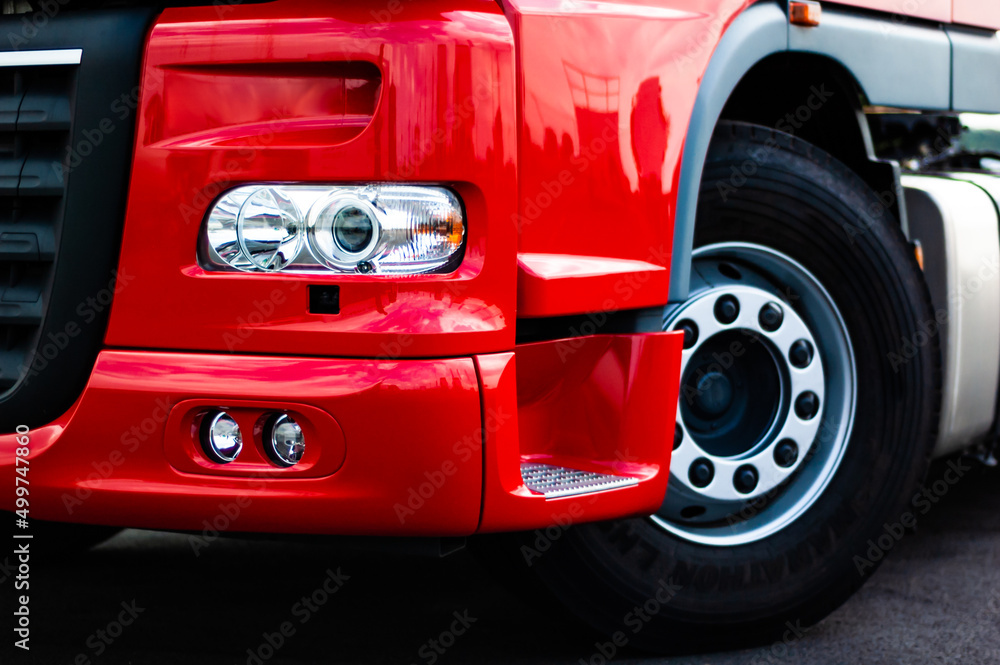 Red semi truck closeup on headlight