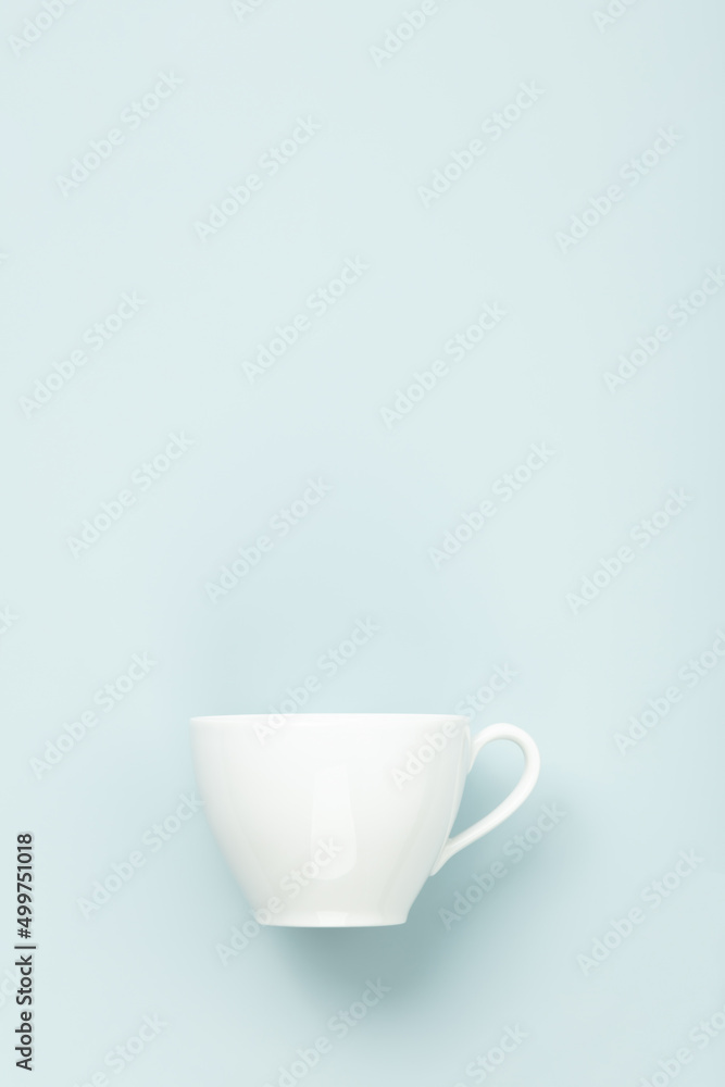 Blank White cup on blue background, flat lay, mock up, copy space Blank White cup on blue background, flat lay, mock up, copy space