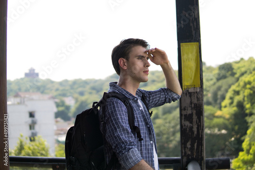 Freedom traveler man with backpack standing on observatory deck and enjoying beautiful landscape view.