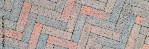 Brown paving slabs laid out in herringbone shape background