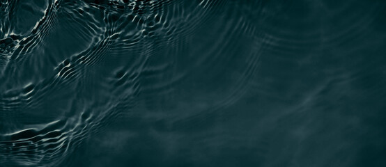 Black transparent clear calm water surface texture with ripples, splashes. Abstract nature banner background. Dark grey water waves. Copy space, top view. Cosmetic moisturizer micellar toner emulsion