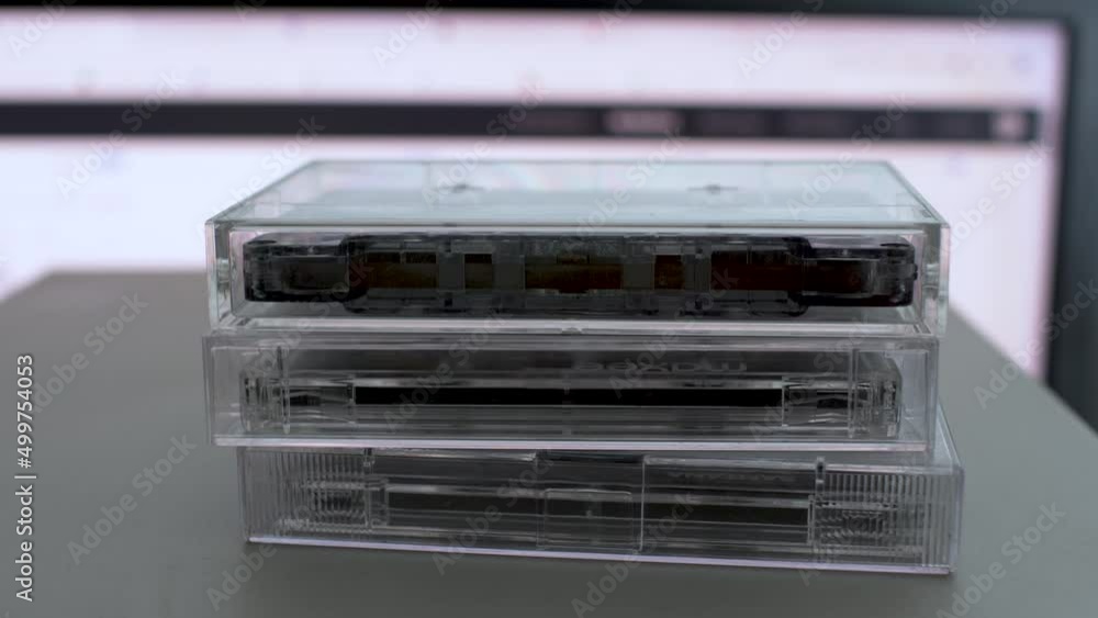 Close Up View Of Retro Cassette Tape Cases Being Stacked On Top Of Each Other. Locked off Close Up View Of Retro Cassette Tape Cases Being Stacked On Top Of Each Other. Locked off