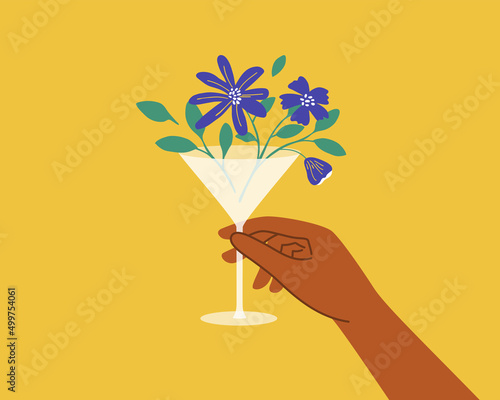 Human hand holding martini glass with blooming flower, leaves. Hello spring or summer abstract vector illustration. Cocktail, fresh juice, floral wine, woman beverage. Beach party poster. Blue flowers