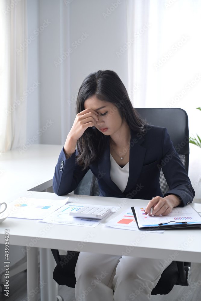 Frustrated businesswoman sitting at her office desk. Frustrated businesswoman sitting at her office desk.