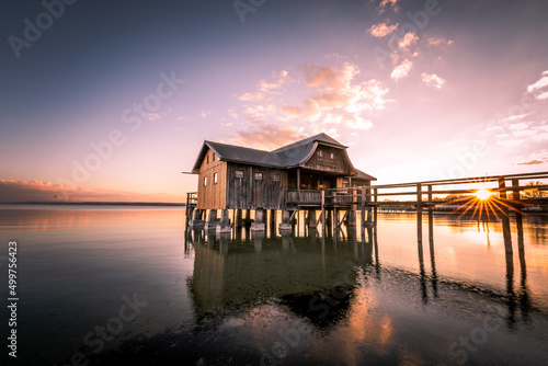 Fotografiet Traditional boathouse at lake Ammersee near Munich, Bavaria, Germany at sunrise
