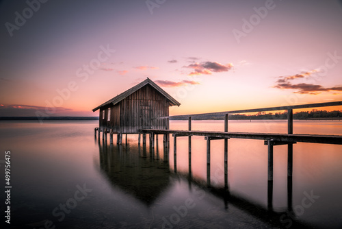 Traditional boathouse at lake Ammersee near Munich, Bavaria, Germany at sunrise.