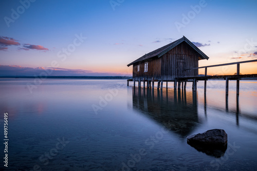 Traditional boathouse at lake Ammersee near Munich  Bavaria  Germany at sunrise.