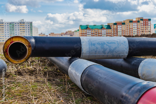 Insulated pipe. Large metal pipes with a plastic sheath at a construction site. Modern pipeline for supplying hot water and heating to a residential area.