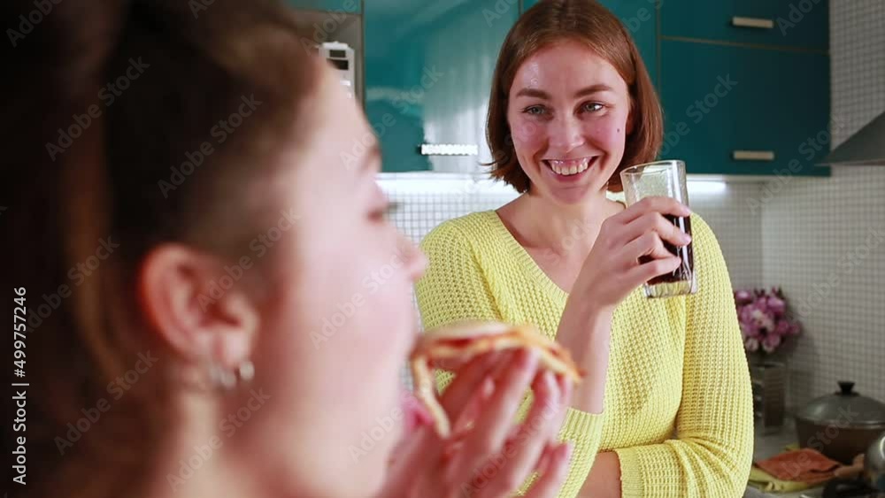 Portrait of two young women having lunch and talking together. Portrait of two young women having lunch and talking together.