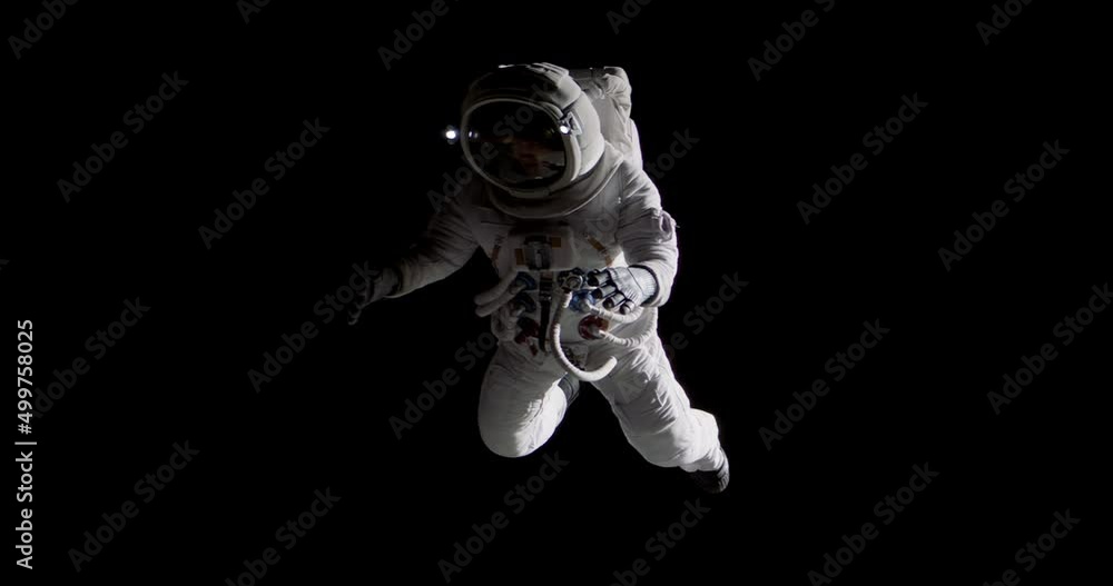 Full portrait of Caucasian female astronaut during spacewalk, black deep space background