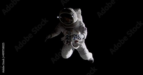 Full portrait of Caucasian female astronaut during spacewalk, black deep space background photo