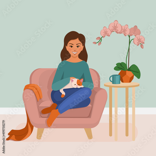A girl on a chair with a cat.