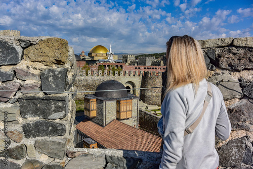 A girl on the background of a view of the Rabati fortress in Akhaltsikhe, Georgia 2019 photo