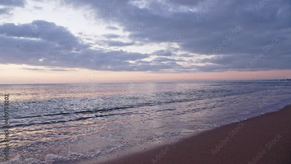 Majestic calm seascape scene with stormy clouds above, pan right view Majestic calm seascape scene with stormy clouds above, pan right view