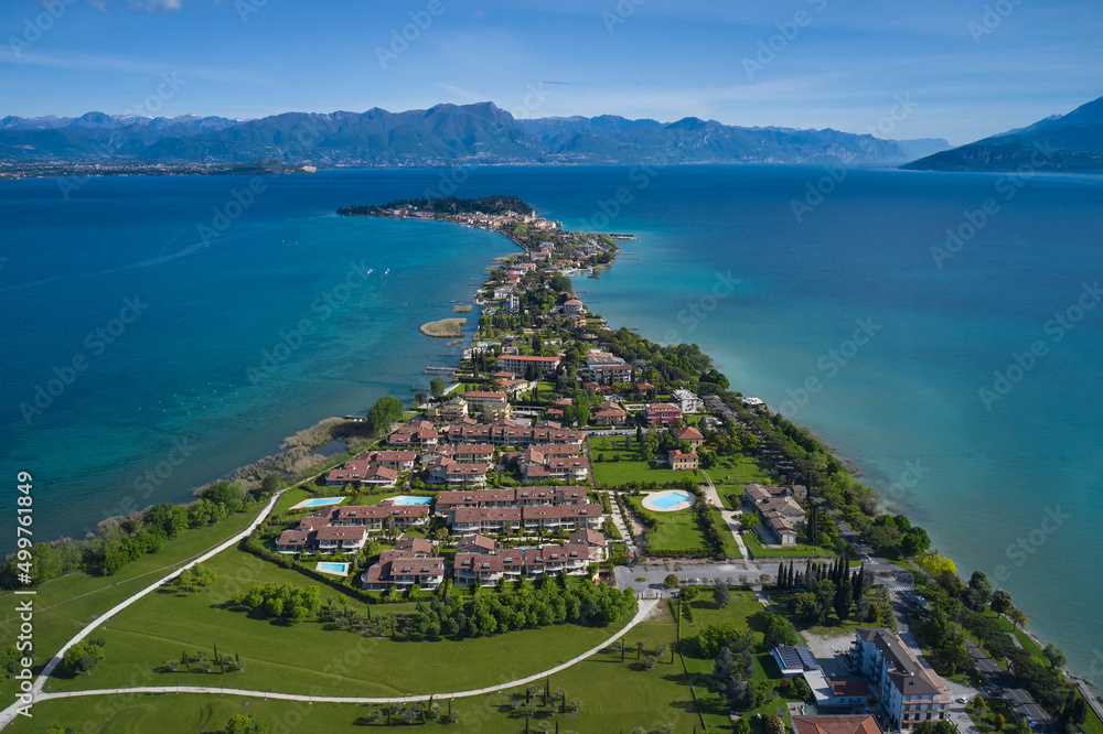 Sirmione drone view. Parco San Vito in Colombare, Sirmione. Panoramic aerial view of the Sirmione peninsula on Lake Garda, Italy. Sirmione, lake garda in the background of the alps.