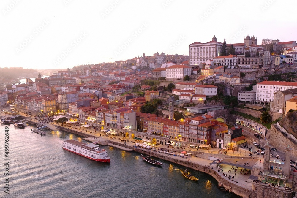 Amazing panorama of Porto lying by Douro River in sunset light, Portugal