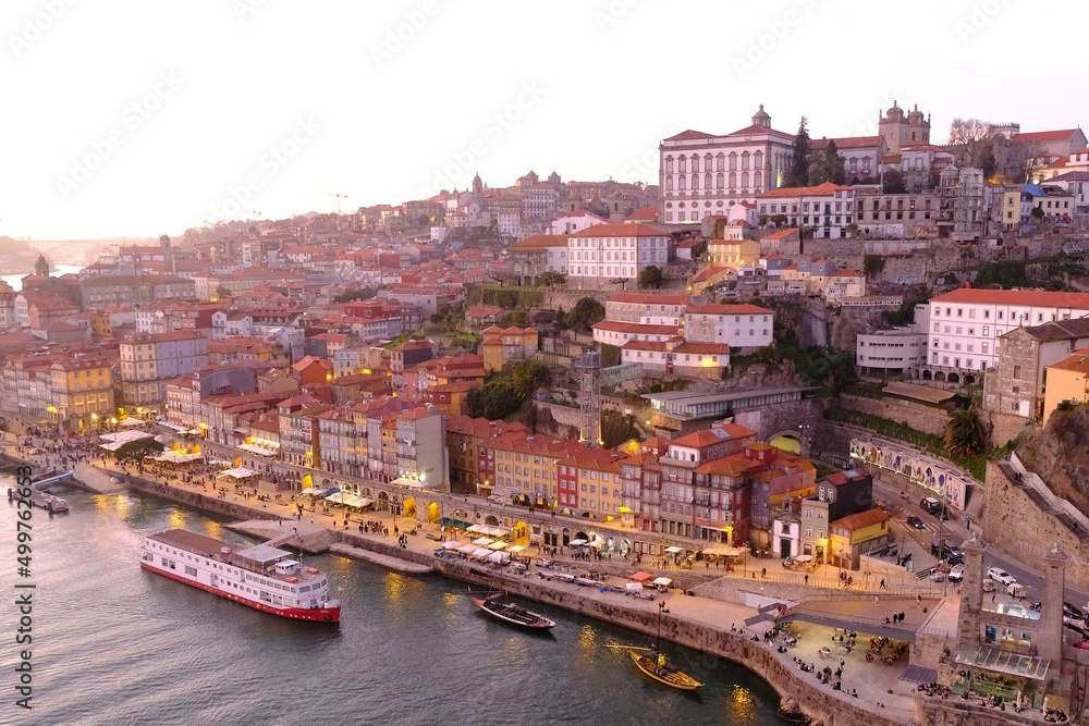 Amazing panorama of Porto lying by Douro River in sunset light, Portugal